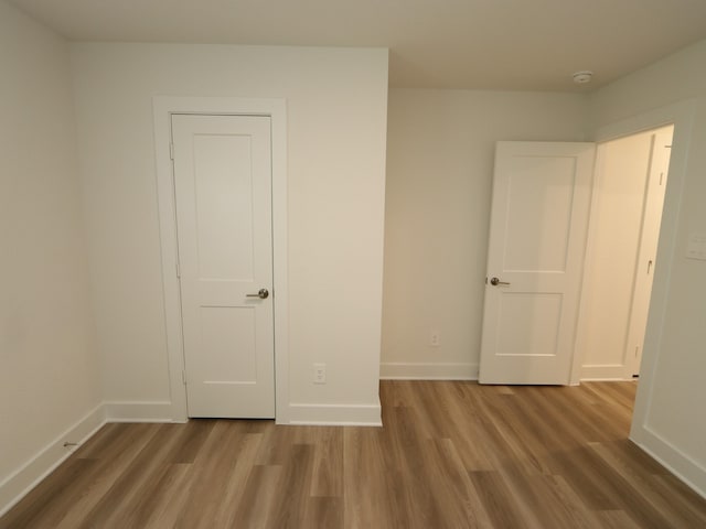 17343 Silver Birch Ct, New Caney, TX 77357 - unfurnished bedroom with wood finished floors and baseboards