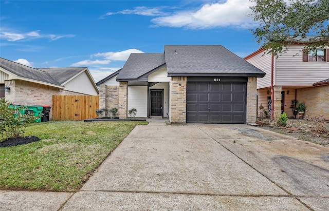 view of front of property featuring a garage and a front yard