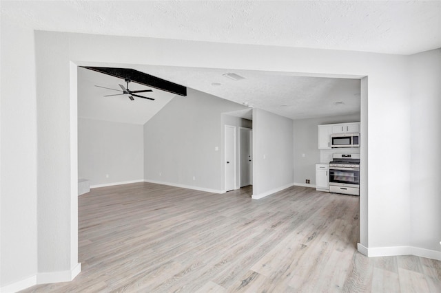 unfurnished living room featuring light wood-type flooring, lofted ceiling with beams, a textured ceiling, and ceiling fan