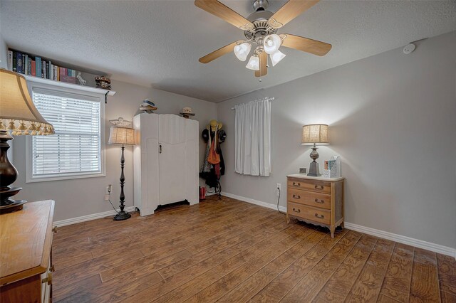 interior space with hardwood / wood-style floors, a textured ceiling, and ceiling fan