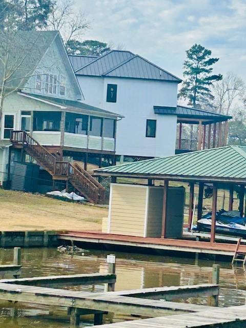 back of property featuring a water view