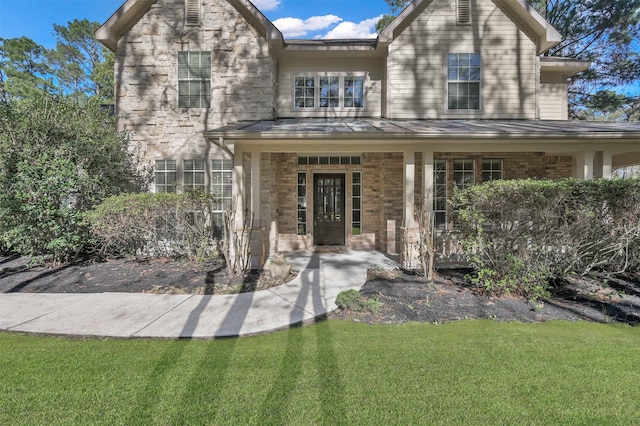 view of front of property with a porch and a front yard