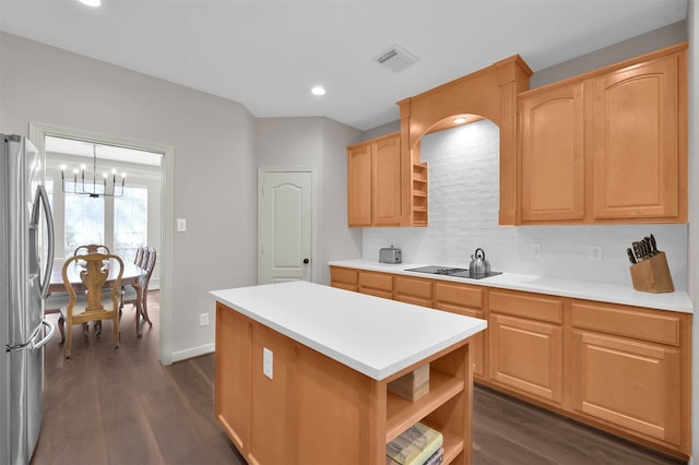 kitchen featuring a center island, dark hardwood / wood-style flooring, light brown cabinetry, stainless steel fridge, and a notable chandelier