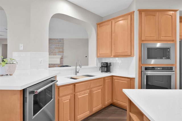 kitchen with wine cooler, oven, sink, built in microwave, and light brown cabinets