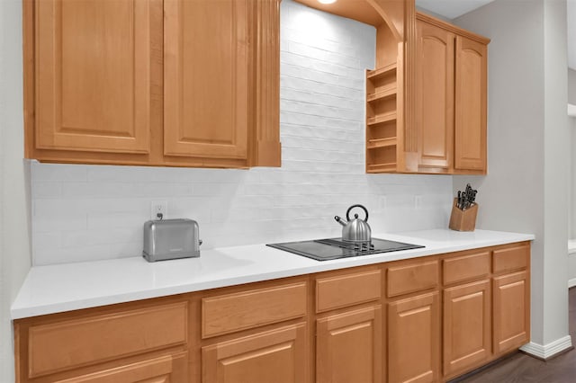 kitchen featuring light brown cabinets, backsplash, dark hardwood / wood-style floors, and black electric stovetop