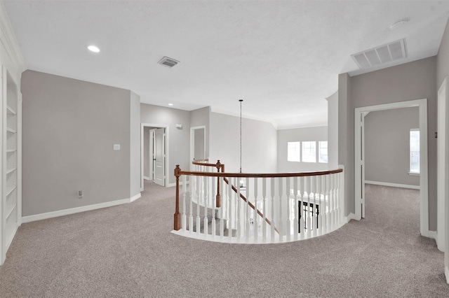 hall with light colored carpet