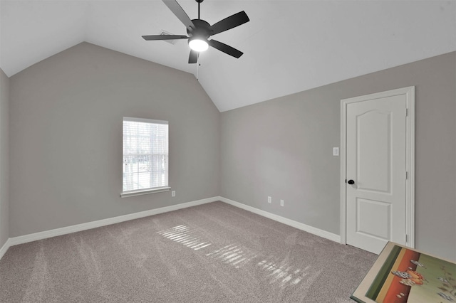 empty room with carpet floors, lofted ceiling, and ceiling fan