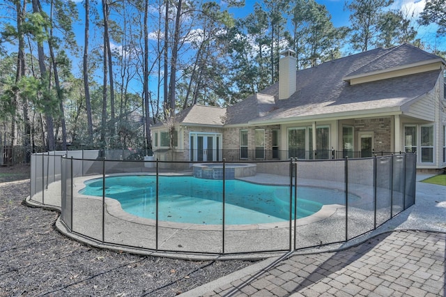 view of pool featuring french doors and a patio