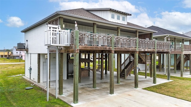 view of front of home featuring a front yard, a patio, and central AC unit