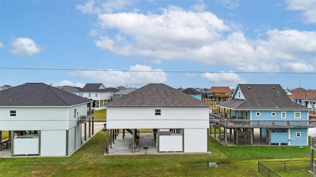 rear view of property featuring a lawn