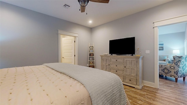 bedroom with ceiling fan and light hardwood / wood-style flooring