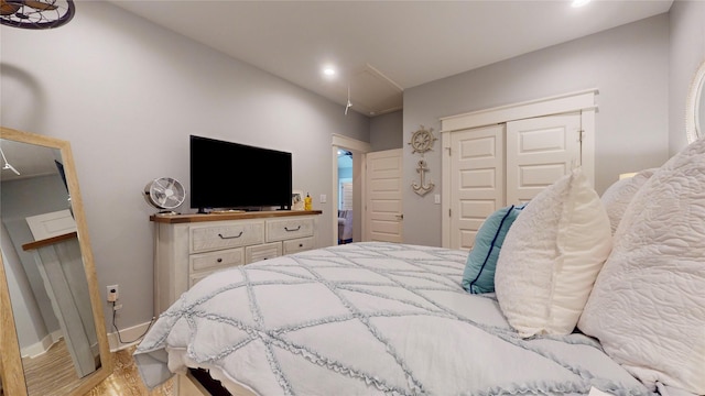 bedroom with a closet and light hardwood / wood-style flooring