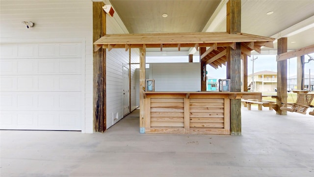 interior space with concrete floors and beamed ceiling