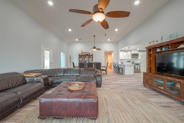 living room with ceiling fan and light hardwood / wood-style floors