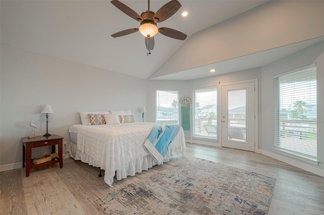 bedroom featuring ceiling fan, multiple windows, access to outside, and vaulted ceiling