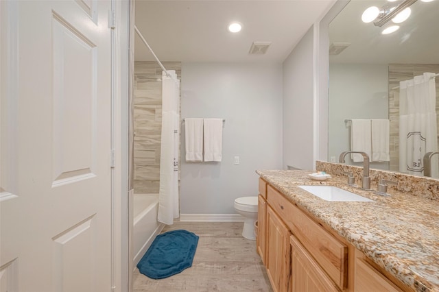 full bathroom with toilet, shower / bath combo, hardwood / wood-style flooring, and vanity