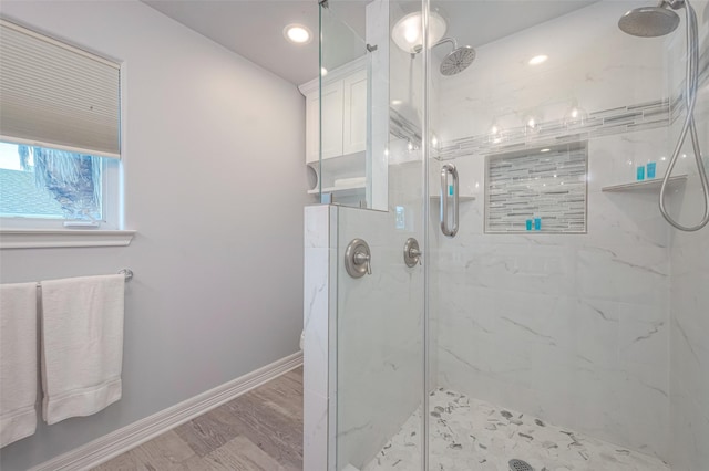 bathroom featuring hardwood / wood-style flooring and walk in shower