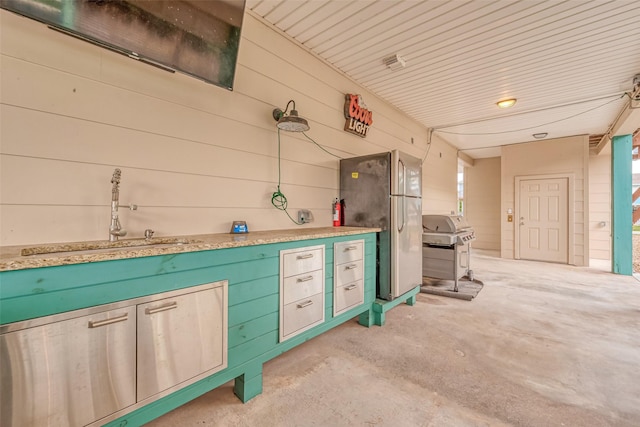 view of patio featuring a grill and sink