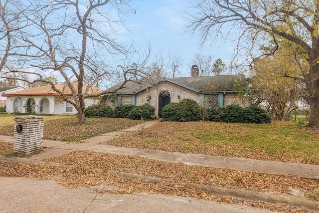 ranch-style house with a front lawn