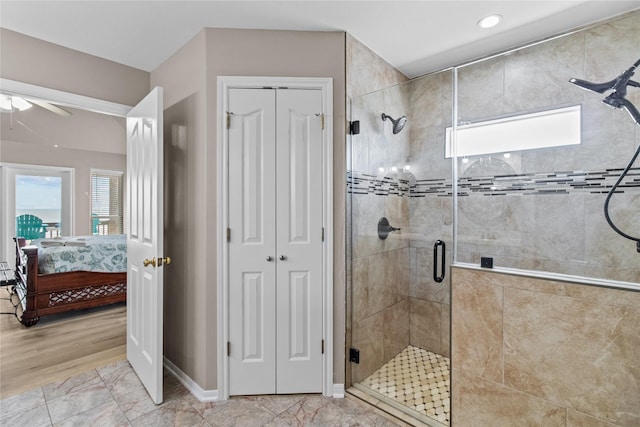 ensuite bathroom with a stall shower, ceiling fan, a closet, and connected bathroom