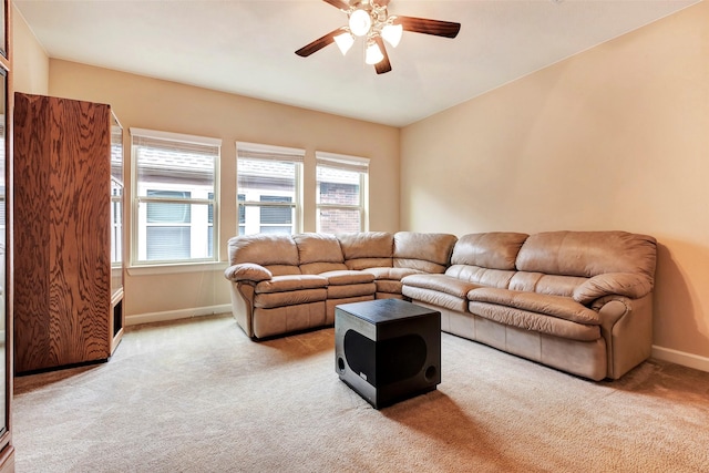 carpeted living room with ceiling fan