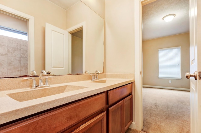 bathroom featuring a healthy amount of sunlight and vanity