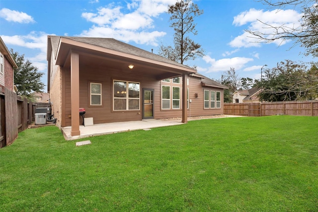 rear view of house featuring a patio area, central AC, and a lawn