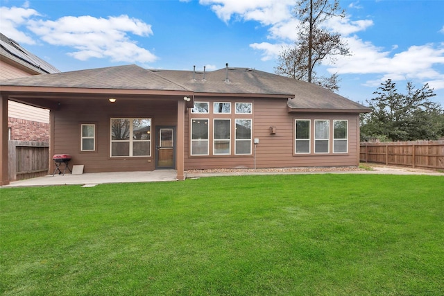 rear view of house featuring a patio area and a yard