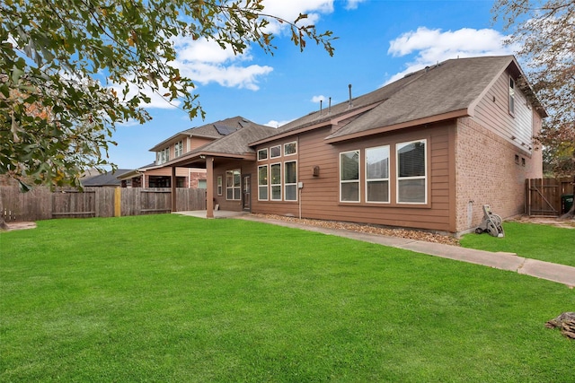 rear view of property with a lawn