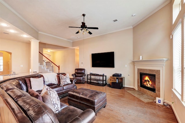 living room with plenty of natural light, wood-type flooring, and crown molding