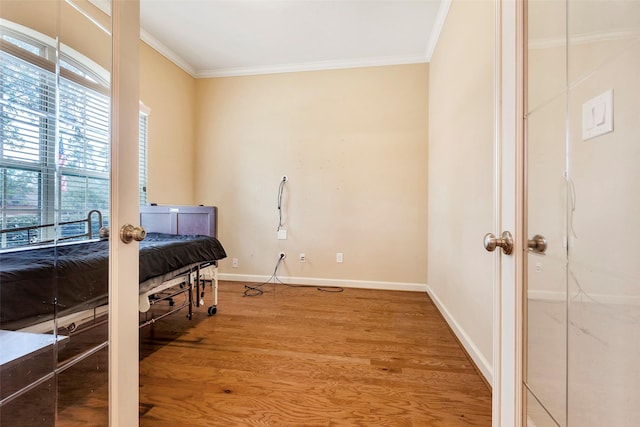 interior space with hardwood / wood-style flooring and ornamental molding