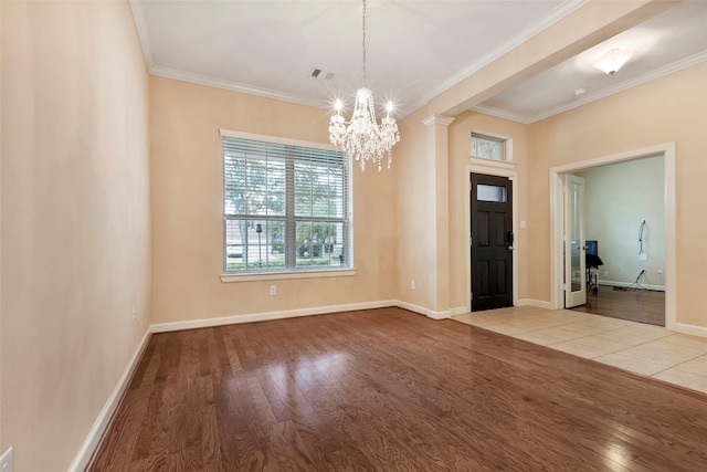 foyer entrance featuring light wood-type flooring, a chandelier, and crown molding