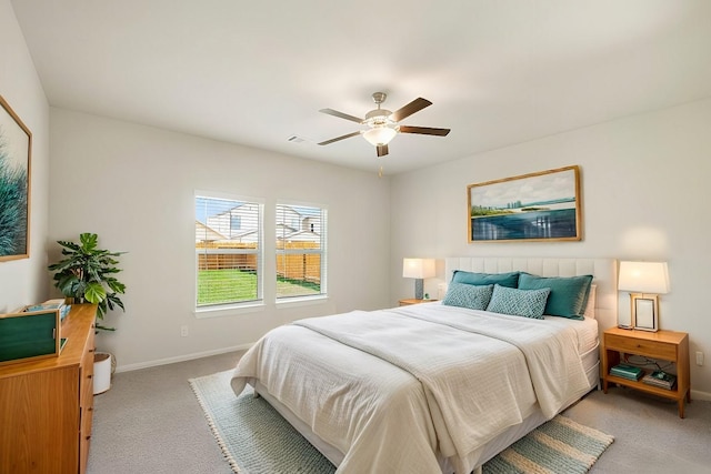 bedroom featuring light carpet and ceiling fan