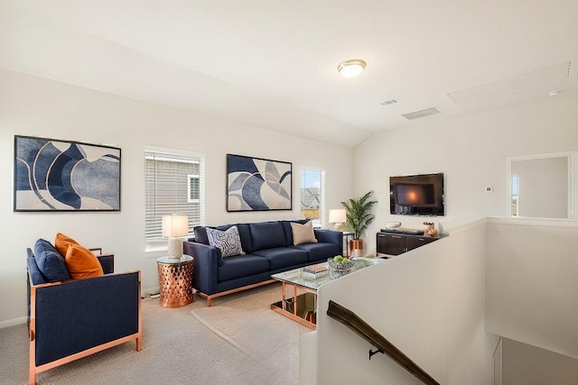 carpeted living room featuring vaulted ceiling