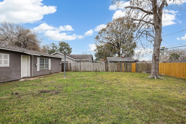 view of yard with a fenced backyard