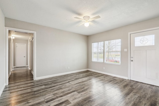 entryway with dark wood-style floors, a textured ceiling, a ceiling fan, and baseboards