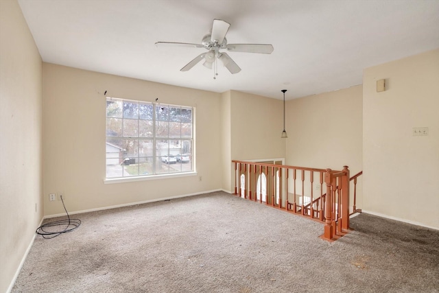 unfurnished room with ceiling fan and carpet flooring