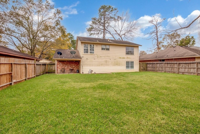 back of property featuring a yard