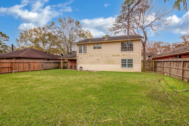 back of house featuring a lawn