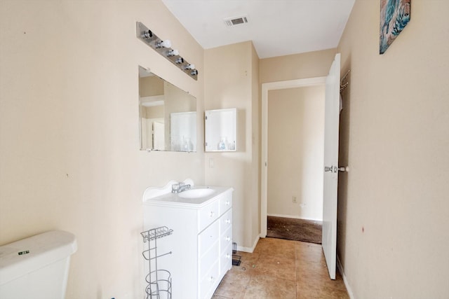 bathroom with toilet and vanity