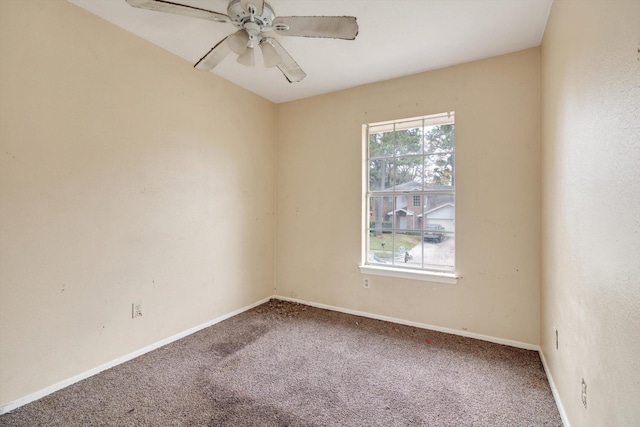 carpeted spare room featuring ceiling fan and a healthy amount of sunlight