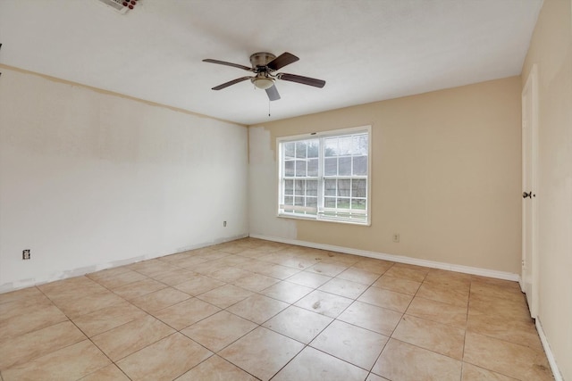 tiled spare room with ceiling fan