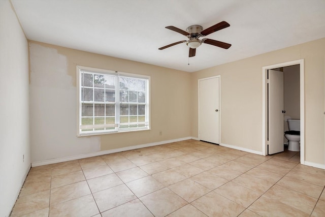 unfurnished bedroom featuring ceiling fan, light tile patterned floors, ensuite bathroom, and a closet