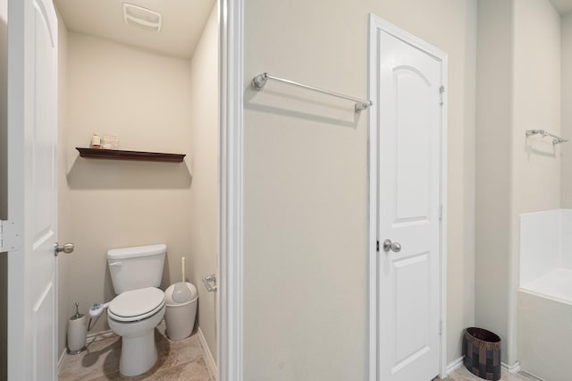 bathroom featuring toilet and a bath