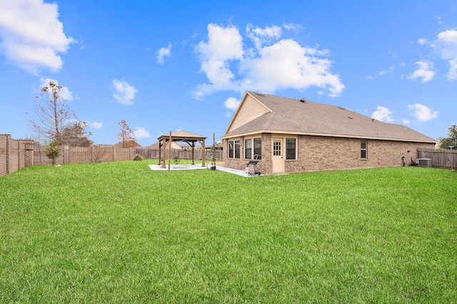 rear view of house featuring a lawn, central AC unit, a gazebo, and a patio