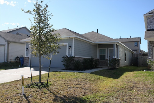 view of front of property with a garage and a front lawn