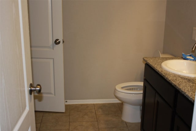 bathroom with tile patterned floors, vanity, and toilet