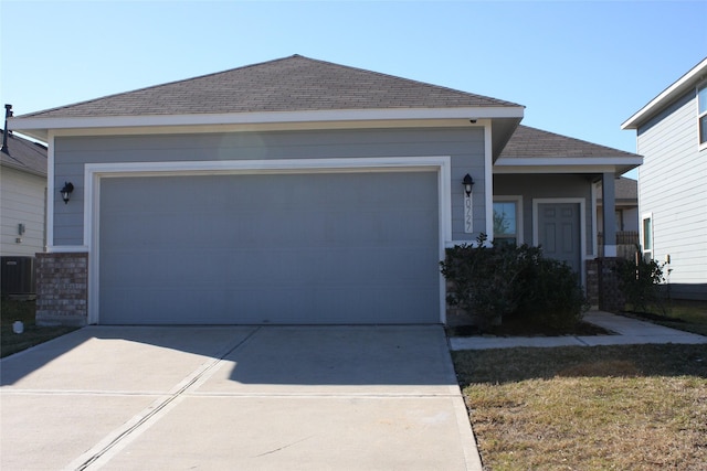 ranch-style home with a garage and a front lawn