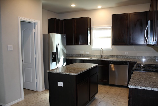 kitchen featuring sink, light tile patterned floors, appliances with stainless steel finishes, dark brown cabinetry, and a kitchen island