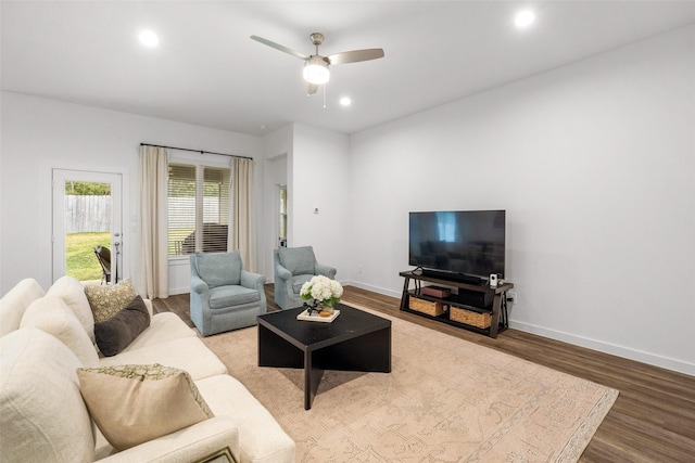 living room featuring ceiling fan and hardwood / wood-style flooring